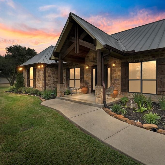 Texas stone ranch home at dusk